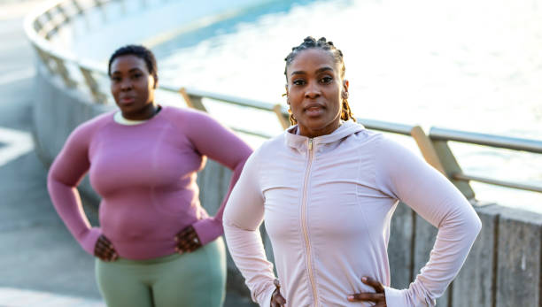 istock Two African-American woman exercising outdoors, warm up 1336580467
