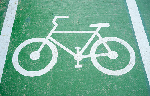 Sign for bicycle painted on the asphalt. Detail of road sign for cyclists in the city, sports and transport respecting the environment.