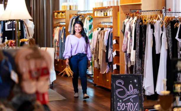 istock Mixed race woman walking through boutique, smiling 1336580746