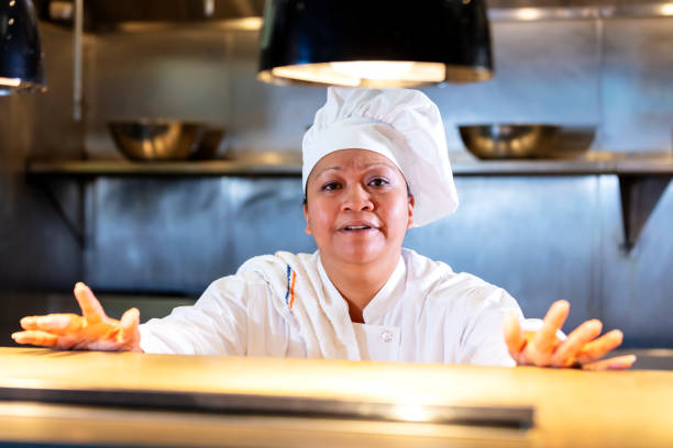 istock Female chef in commercial kitchen behind counter 1336581347