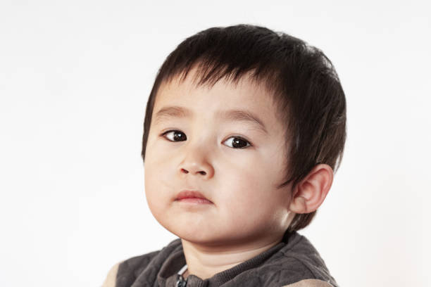 Little Asian boy portrait on white background.