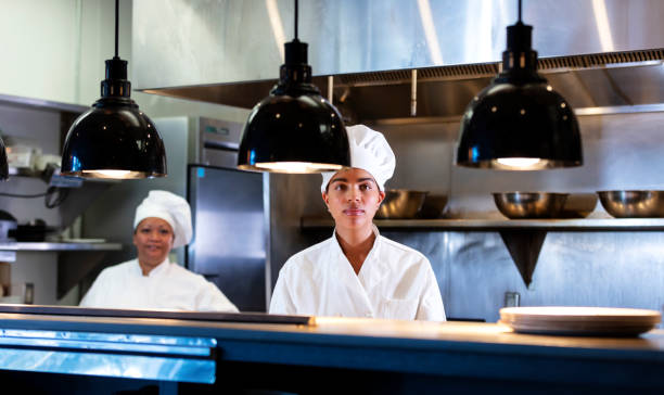 istock Two women working as chefs in restaurant kitchen 1336586550
