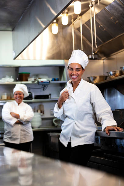 istock Two women working as chefs in restaurant kitchen 1336587598