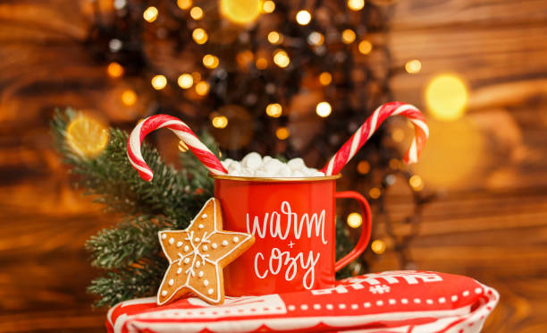istock Christmas mug with hot drink and candy cane. Festive bokeh. 1336588443