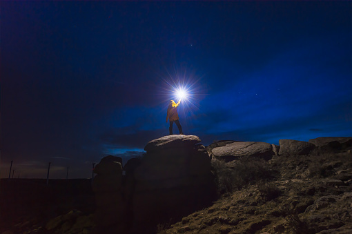 A photographer under the night sky with a lamp