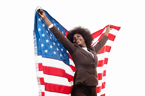 young black adult businesswoman waving usa flag, smiling happy, on white background