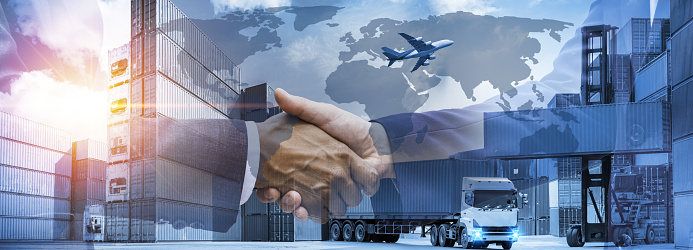 Double exposure businessman handshake best business cooparation with logistics and transportation of container cargo ship warehouse and cargo plane background.