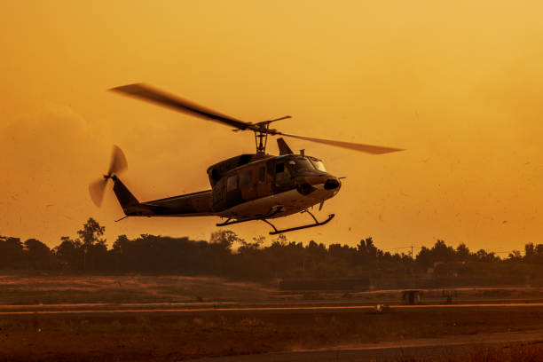 istock Silhouette Helicopter flying on with sky with soft sunsky background. 1336602201