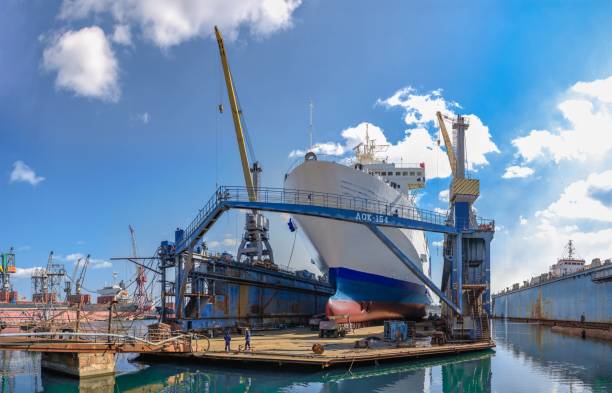 large ship in dry dock of shipyard - industrial ship shipping painting repairing imagens e fotografias de stock