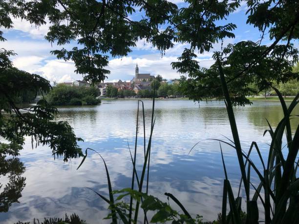 istock Small town silhouette with a lake in the foreground 1336606858