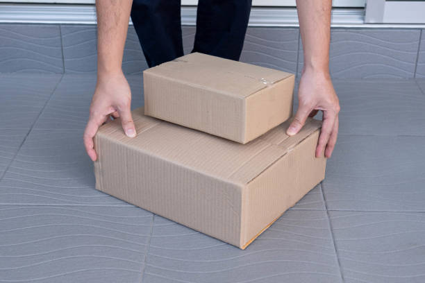 istock E-commerce concept a man leaving home and lifting the boxes for sending them to his customers via tracking express. 1336608852