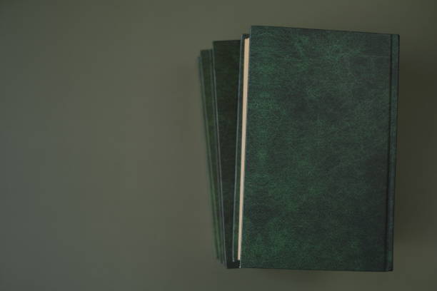 istock Reading of books. Knowledge and education. Books stack on a dark green background. Business literature and trainings. Knowledge concept.Literature and reading concept. 1336609683