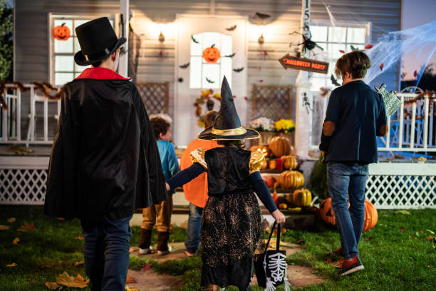 istock Young kids trick or treating at night during Halloween 1336609811