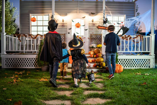 istock Young kids trick or treating at night during Halloween 1336609814