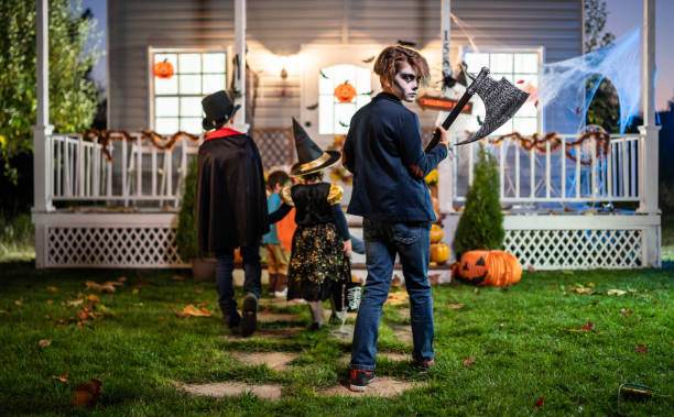 istock Young kids trick or treating at night during Halloween 1336609825
