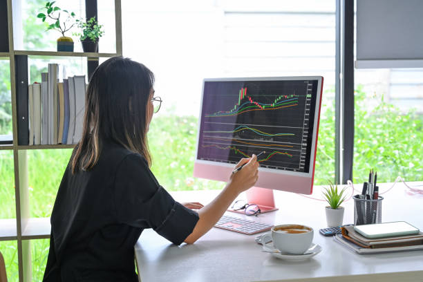 istock Businesswoman analyzing investment charts with computer in modern office. 1336612100