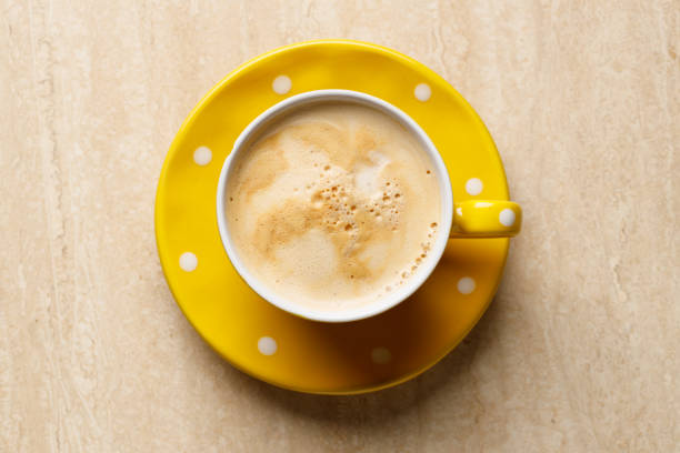 Cup of espresso coffee on a textured surface.