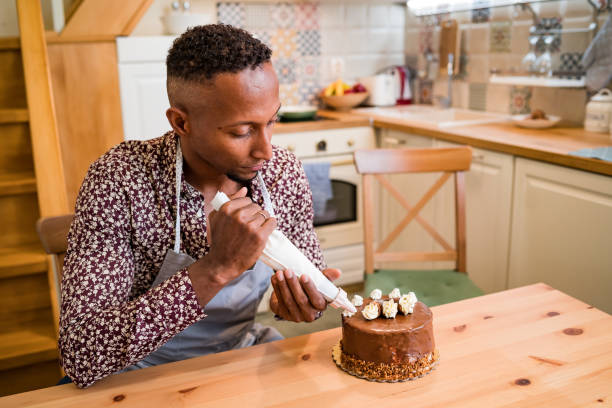 istock Brazilian man decorating a cake at home 1336616260