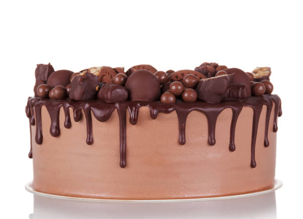 istock Gorgeous chocolate cake decorated with chocolates and cookies isolated on white 1336618605