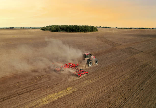 istock Agricultural tractor on cultivating field for sowing seeds. 1336620198