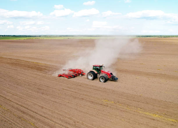 istock Agricultural tractor on cultivating field for sowing seeds. 1336620200