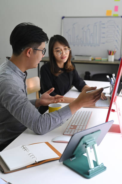 istock Group of business people discussing business data on computer together in office. 1336621473