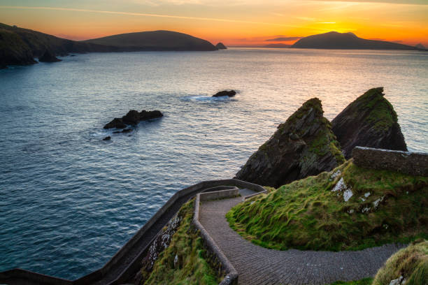 Beautiful scenery of the Atlantic Ocean coastline on Dingle Peninsula, Amazing sunset over the Atlantic Ocean in the Dunquin Pier on Dingle Peninsula, County Kerry, Ireland. county kerry photos stock pictures, royalty-free photos & images