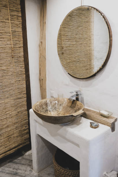 istock Loft style bathroom with washbasin and round mirror 1336625284