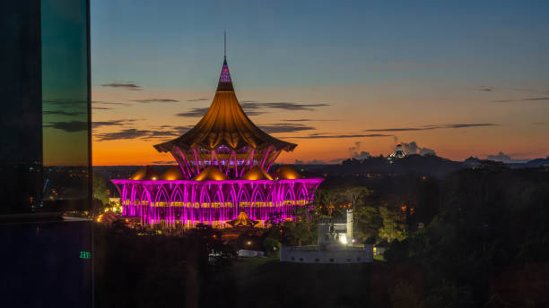 Sunset in Kuching, Sarawak Sunset in Kuching, Sarawak with the state legislative council, an ancient Fort Margherita  and the city council of northern Kuching a distance away kuching waterfront stock pictures, royalty-free photos & images