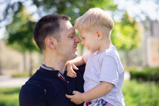istock Affectionate father carrying little son in arms, making faces and enjoying outdoors together 1336625488