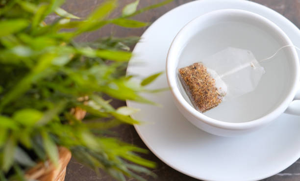istock Herbal tea next to the flower pot on the patterned marble 1336626848