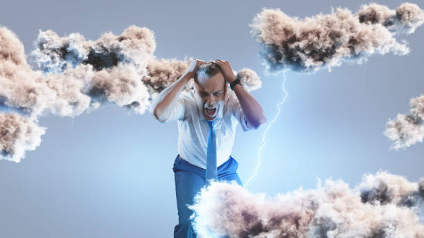 istock Overwhelmed businessman screaming amidst thunderclouds 1336630344