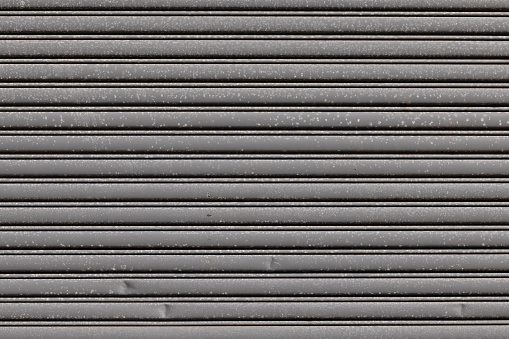 Metal garage door with repeating pattern.