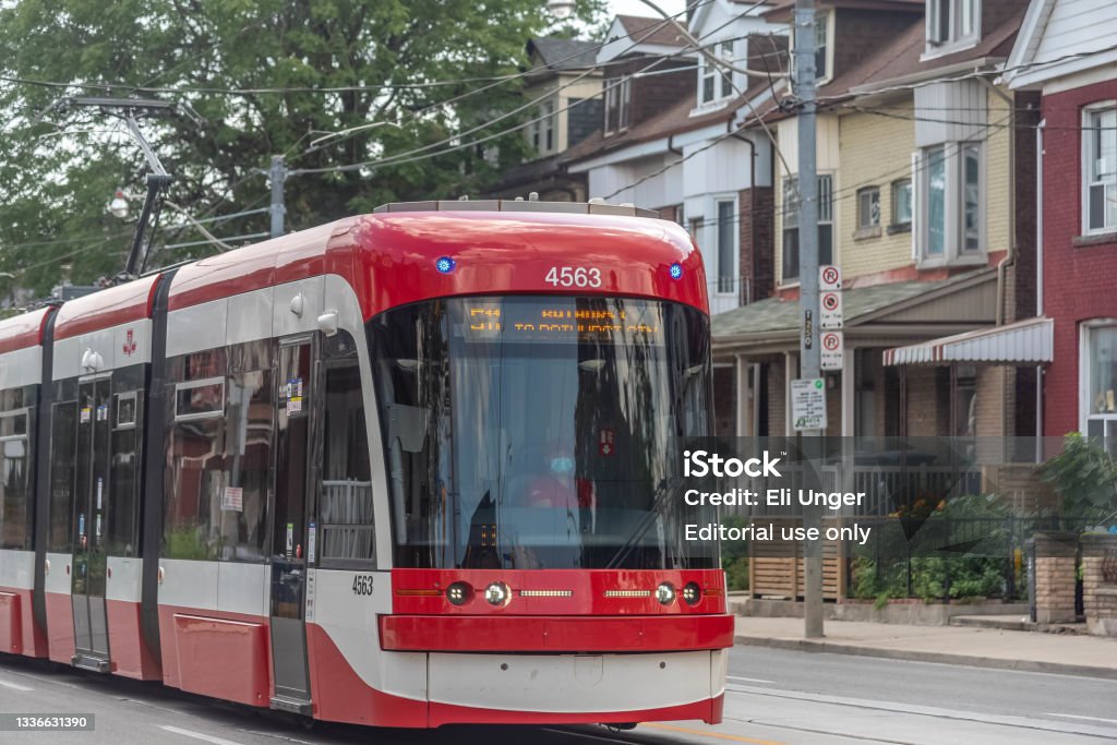 TTC street car Toronto, Ontario, Canada- August, 23, 2021: A TTC street car driving on a street in downtown Toronto, while the driver is wearing a mask to protect others from Covid Downtown District Stock Photo