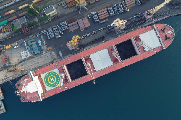 istock Container ship in export and import business and logistics. Shipping cargo to harbor by crane. Water transport International. Aerial view 1336631946