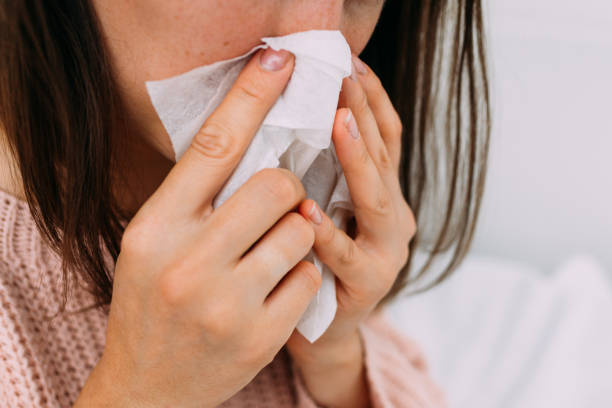 istock The person has a cold and blows his nose into a napkin 1336632961
