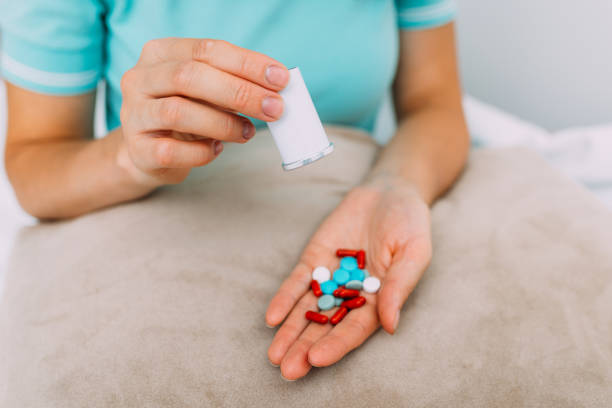 istock Person pours medicine from container into hand 1336632965