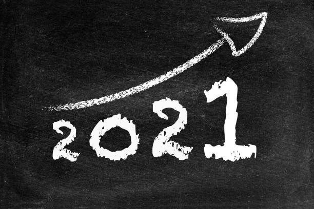 istock Year 2021 with ascending arrow on blackboard 1336634130