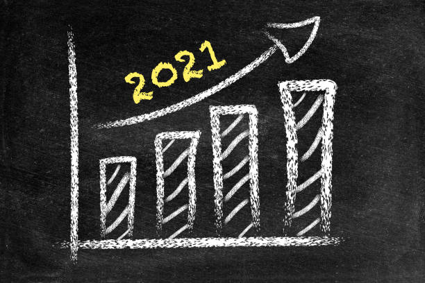istock Year 2021, ascending arrow and bar graph on blackboard 1336634336