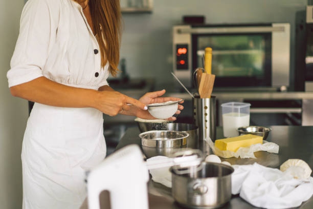 istock Hands working with dough preparation recipe bread, pizza or pie making ingridients. Butter, milk, eggs, sugar the concept of homemade pastry, cooking cakes 1336634960
