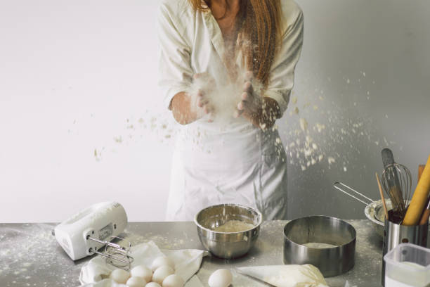 istock Hands working with dough preparation recipe bread, pizza or pie making ingridients. Butter, milk, eggs, sugar the concept of homemade pastry, cooking cakes 1336634996