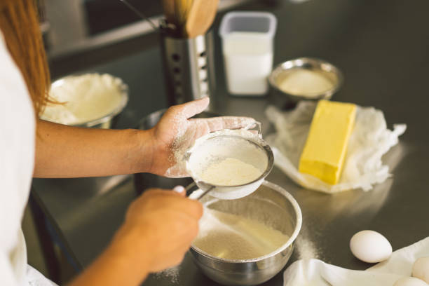 istock Hands working with dough preparation recipe bread, pizza or pie making ingridients. Butter, milk, eggs, sugar the concept of homemade pastry, cooking cakes 1336634997