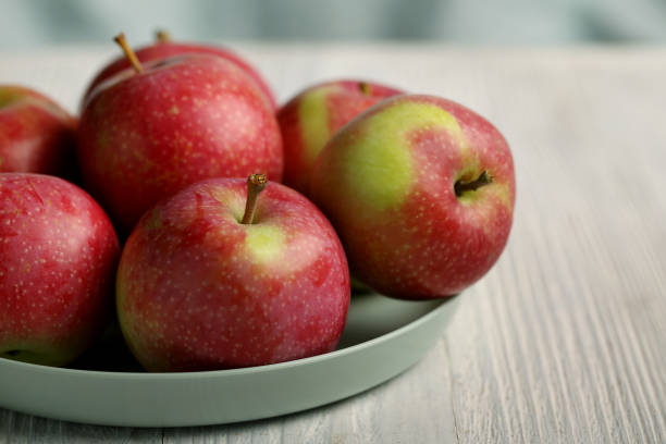 istock Apples on plate, red and green apples 1336635020