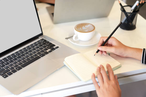 istock Cropped image of woman take notes on notebook at office 1336636165