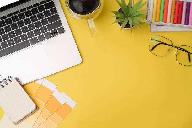 istock Top view designer workspace with laptop computer, glasses, coffee cup and color swatch. 1336636271