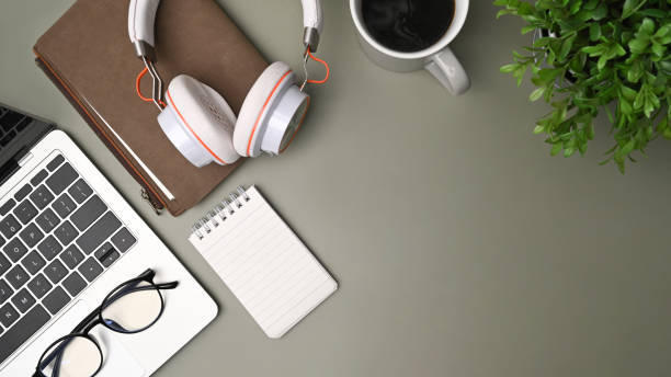 istock Top view laptop computer, notebook and coffee cup on green background. 1336637943