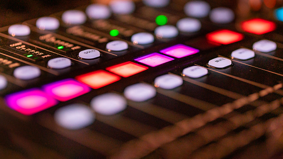 Part of a modern digital studio mixing pult with illuminated buttons