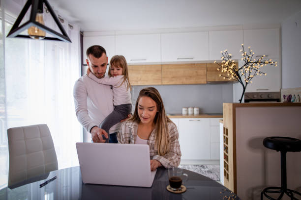 istock Young family using laptop at home 1336641151