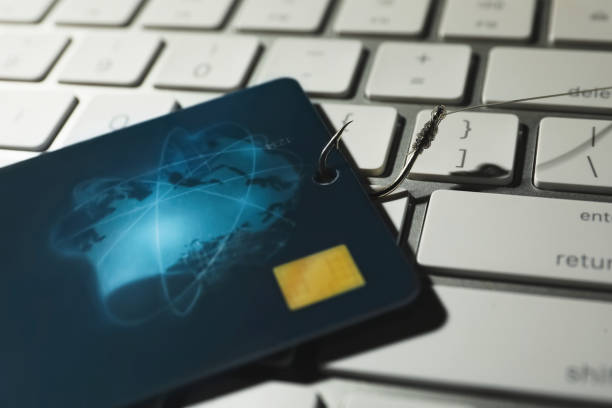 istock Hook with credit card on computer keyboard, closeup. Cyber crime concept 1336641186