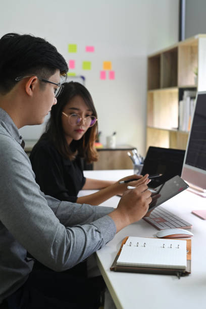 istock Two business colleagues analyzing financial graph on digital tablet together. 1336641506